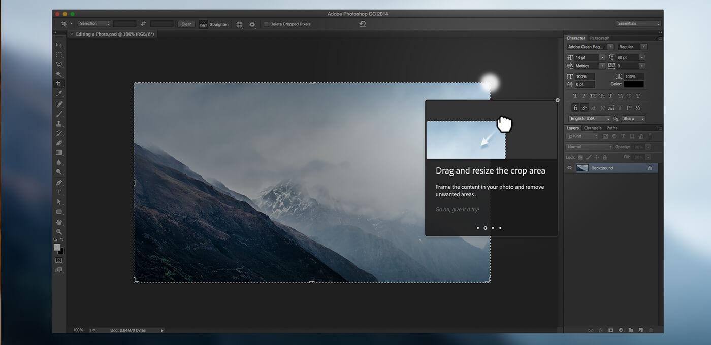 Screenshot of Adobe Photoshop CC 2014 showing a mountain landscape image with a dashed crop outline and a tip saying Drag and resize the crop area.