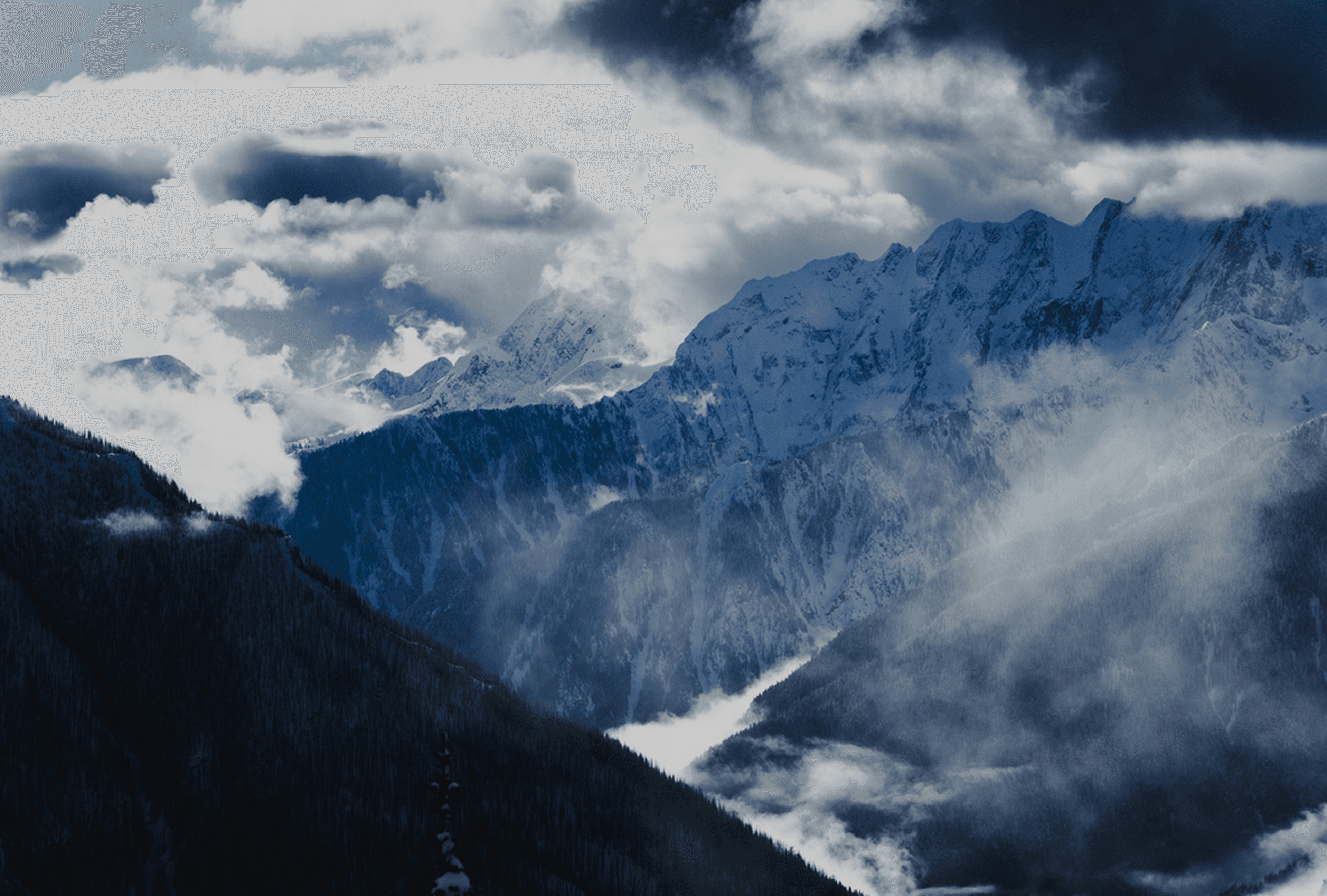 Futuristic oval glass house in a rocky desert at sunset; curved exterior with glass walls reveals a furnished interior, with wide curved steps leading to the entrance.