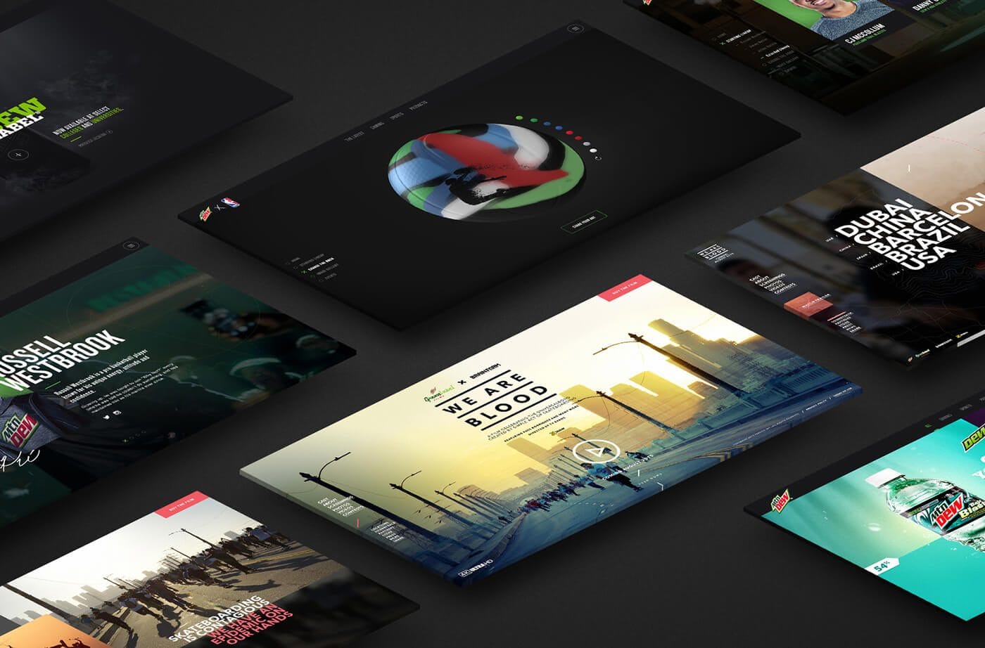 Dark background with several angled design mockups; a central pale-yellow cityscape poster reads "WE ARE BLOOD," surrounded by other colorful layouts.