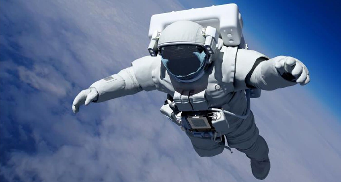 An astronaut in a white spacesuit floats in space, reaching forward above Earth with a blue planet and clouds visible.