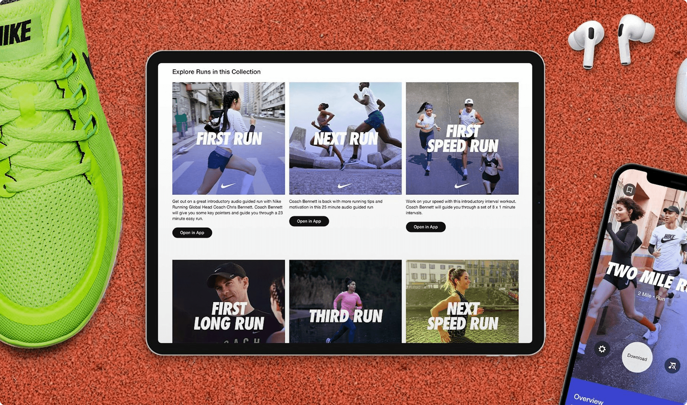 A flat lay image featuring a vibrant green Nike running shoe on the left, a tablet in the center displaying a "Explore Runs in this Collection" interface with various guided run options like "FIRST RUN," "NEXT RUN," and "FIRST SPEED RUN," and a smartphone on the right showing a "TWO MILE RUN" interface. White wireless earbuds are placed above the smartphone. The background is a red running track surface.