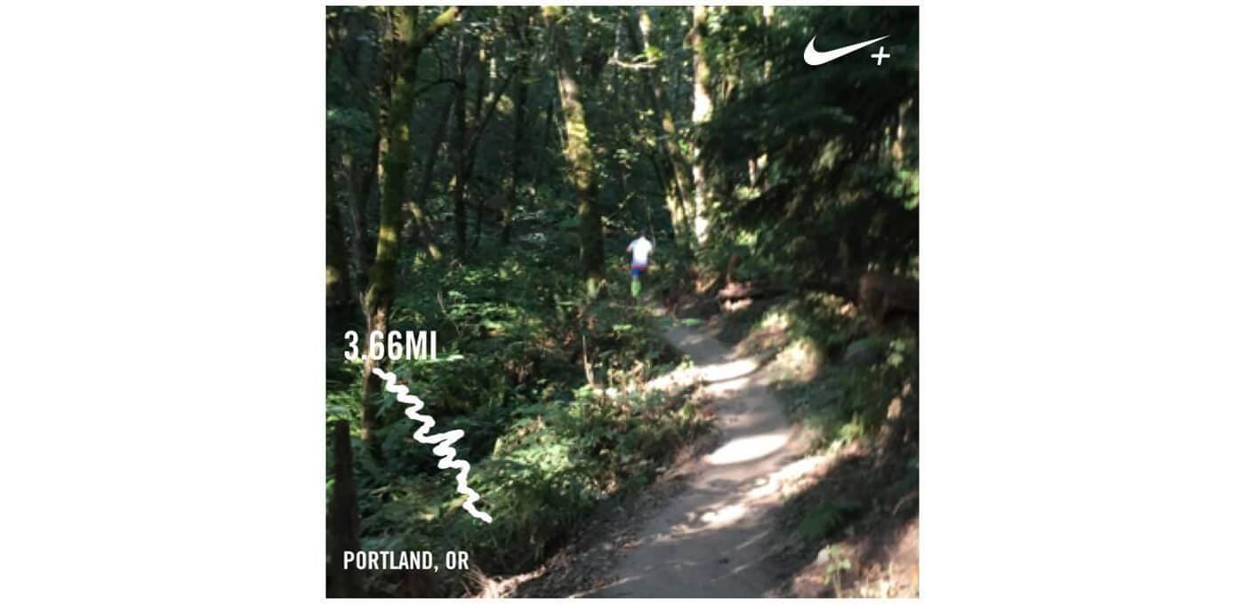 Runner on a sunlit forest trail with trees on both sides; Nike+ logo top right, 3.66 mi label on the left, Portland, OR caption at bottom.