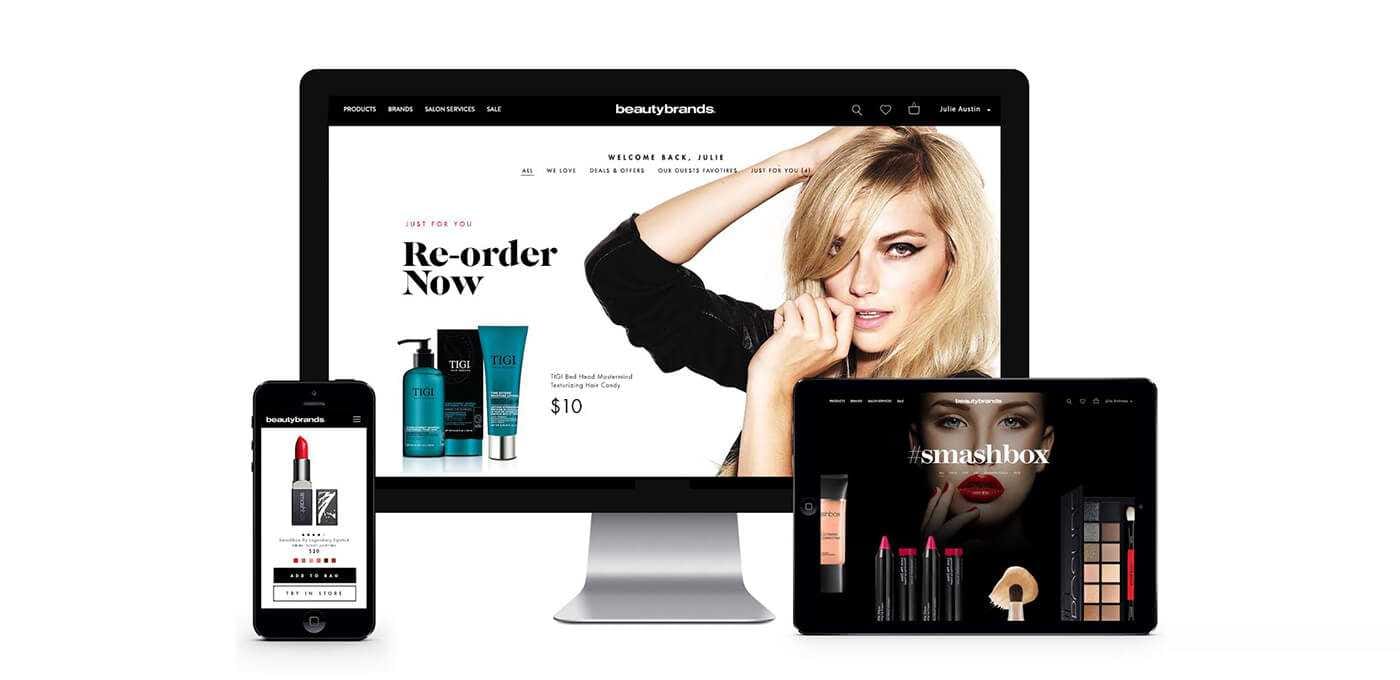 Desktop monitor with a beauty brands site featuring a large model image; a tablet and phone show makeup products.
