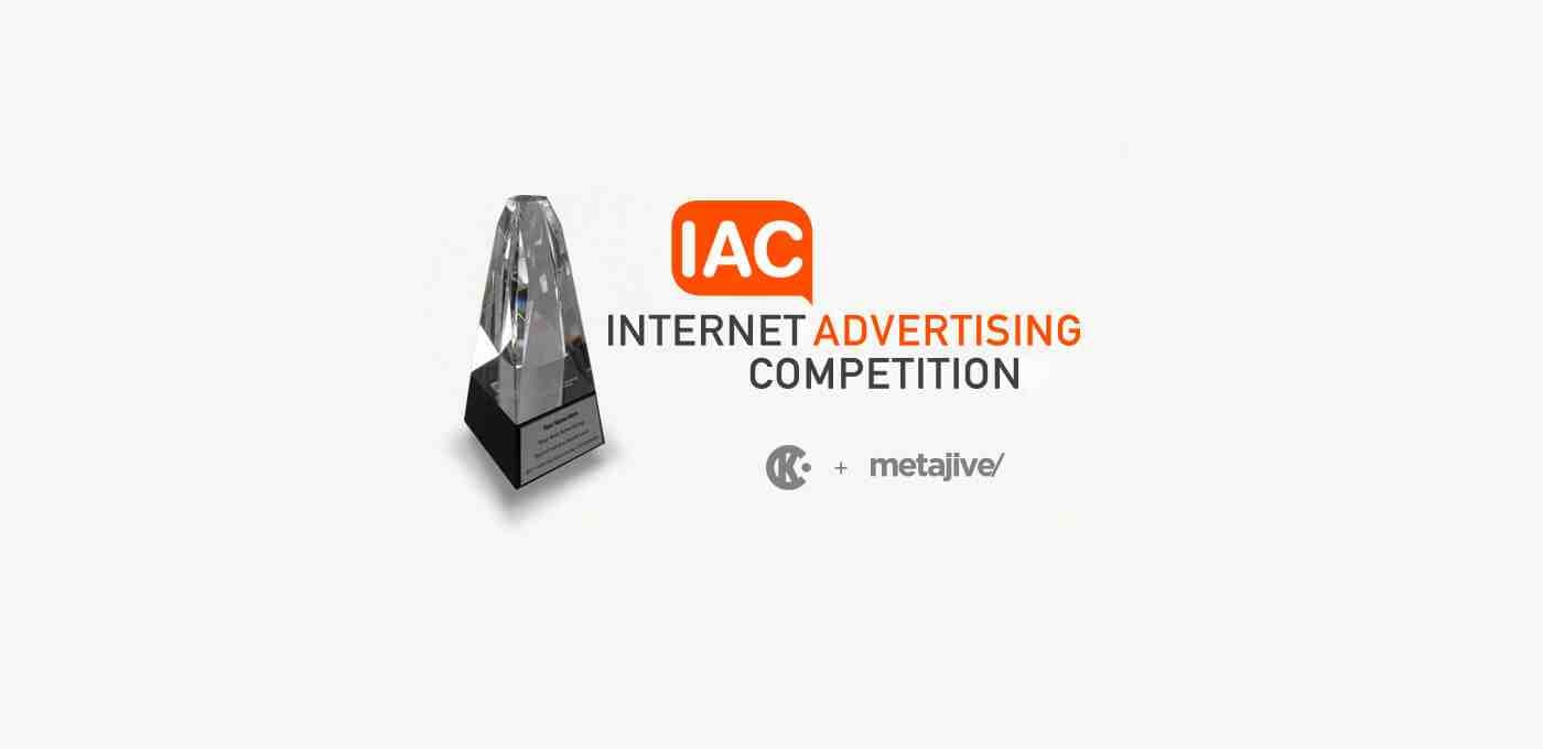 Crystal trophy on a black base beside the IAC Internet Advertising Competition branding, featuring orange “ADVERTISING” text and subtle partner logos.