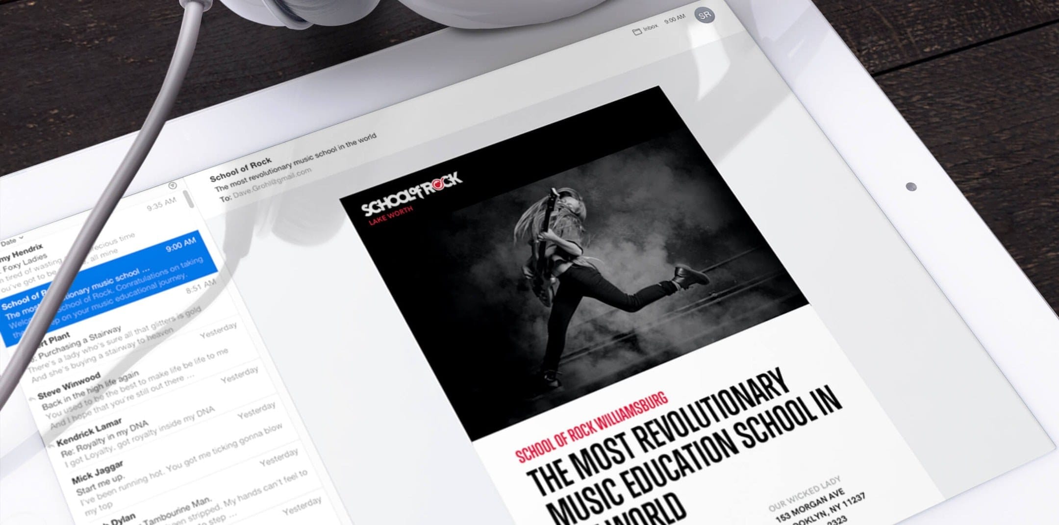 iPad screen showing a black-and-white poster of a guitarist leaping in a smoky background, with red School of Rock Williamsburg and bold music-education text.